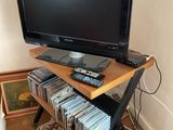 a flat screen tv sitting on top of a wooden stand