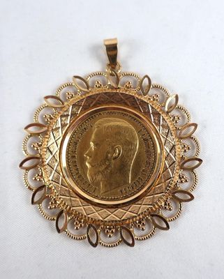 a close up of a gold medal with a picture of a man on it