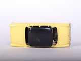 a yellow toy car that is sitting on a white surface