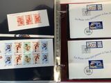 four different stamps in a binder on a table
