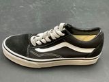 vans old skooler black and white sneakers on a gray surface