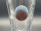 a glass with a ball inside of it on a table
