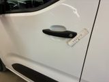 a white car with a black handle and a sticker on it