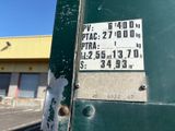a sign on the side of a green pole