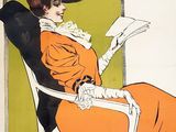 a woman sitting in a chair reading a book