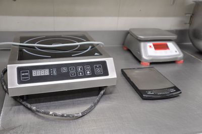 a cell phone sitting on a counter next to a stove top