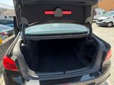 the back of a car with its trunk open in a parking lot