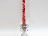 une bougie dans un vase en verre sur fond blanc