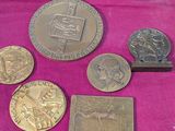 some of the coins are sitting on a pink cloth