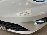 a white car with a sticker on the front of it