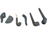 four different types of pipe smokings are lined up on a white surface