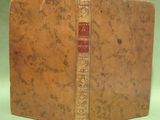 an old book sitting on top of a green table next to a green wall