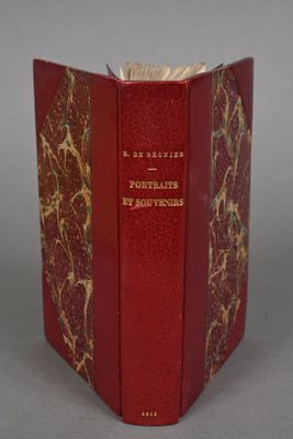 a red book with gold writing on it sitting on a table