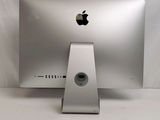 a silver apple desktop computer sitting on a white surface