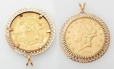two gold coin pendants with a woman ' s head and a man ' s head