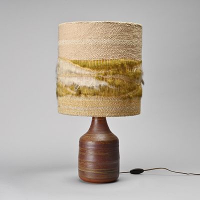 the table lamp is made of wood and has a brown base