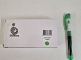 a green pen sitting next to a white box with a barcode on it