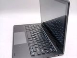 a laptop computer sitting on top of a white table