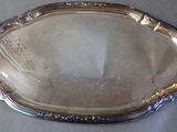 a silver tray with a mirror on it on a table