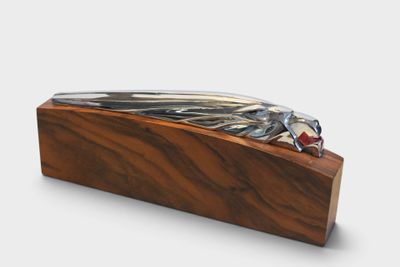 a wooden box with a metal object on it