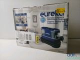 packaging of a blue and black vacuum cleaner sitting on top of a white counter