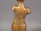 bronze statue of a female torso on a wooden base