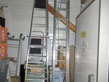 a ladder that is next to a refrigerator in a room