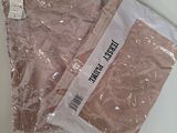 two bags of pink underwear sitting on a table