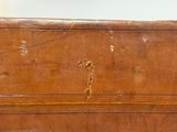 a brown piece of luggage sitting on top of a table