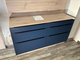 a blue chest of drawers in a room with wood flooring