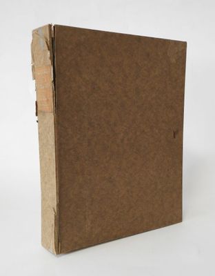 a brown book with a brown cover sitting on top of a white surface