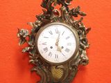 une horloge accrochée au mur avec un oiseau dessus