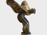 statue of a woman holding a butterfly on a black marble base