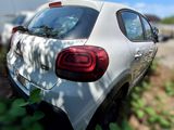 a car that is parked in the grass next to a tree