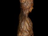 an image of a wooden statue of a woman with a hat on her head