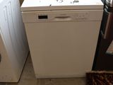 a white dishwasher sitting next to a washing machine