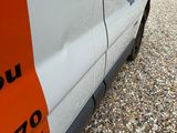a van that has been painted orange and white with a sticker on the side