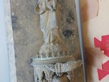 a statue of a woman on a pedestal next to a box