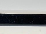 an image of a black pen on a white surface