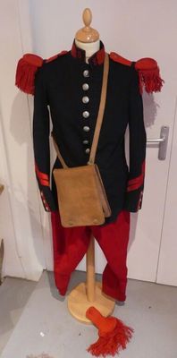 a mannequin dressed in red pants and a black jacket