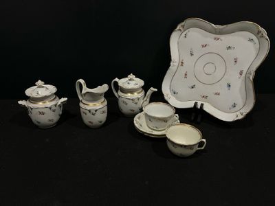 Plusieurs pièces de porcelaine sont posées sur une surface noire.