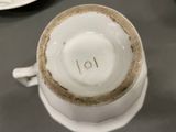 a coffee cup with a number on it sitting on a saucer