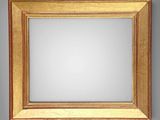 an image of a gold framed mirror against a gray wall