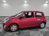 a small red car that is parked on a checkered floor