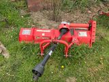 une machine rouge qui est garée dans l'herbe