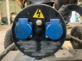 a close up of a blue and black machine in a garage