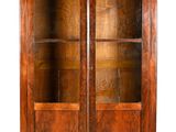 an old wooden bookcase with glass doors and shelves