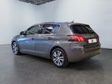 the back end of a silver car in a white room