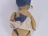 a small doll with a bandage on it ' s head