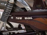 a close up of a motorcycle with a new west sticker on it